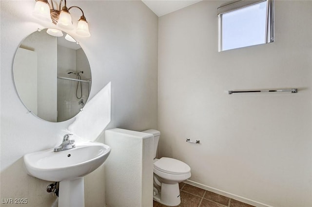 bathroom with a shower, toilet, and tile patterned floors