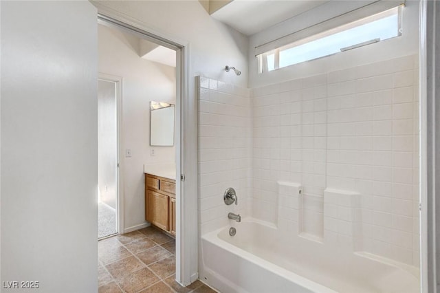 full bathroom with washtub / shower combination, tile patterned flooring, vanity, and baseboards