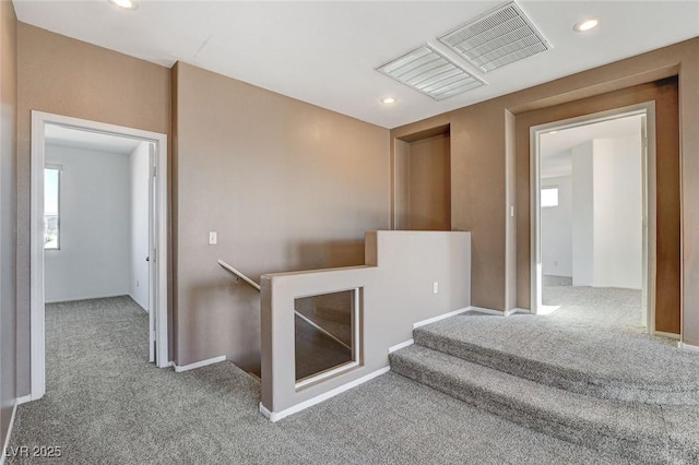 interior space with baseboards, visible vents, carpet flooring, and recessed lighting