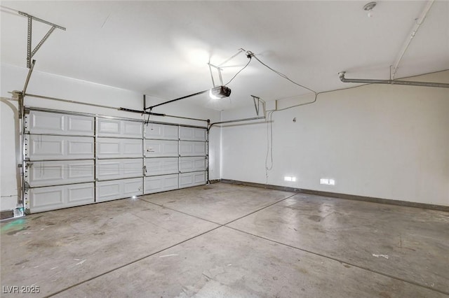 garage with baseboards and a garage door opener