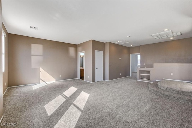 unfurnished living room with carpet floors, recessed lighting, and visible vents