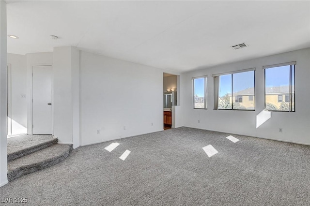 unfurnished room featuring carpet flooring and visible vents