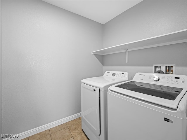 laundry room featuring laundry area, baseboards, separate washer and dryer, and light tile patterned flooring