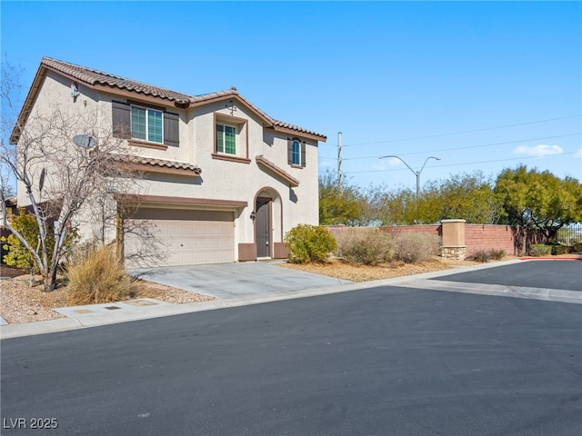 mediterranean / spanish-style home with a tile roof, stucco siding, an attached garage, fence, and driveway