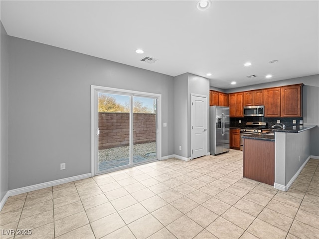 kitchen with stainless steel appliances, recessed lighting, visible vents, brown cabinetry, and baseboards