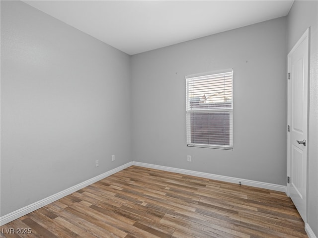 empty room featuring baseboards and wood finished floors