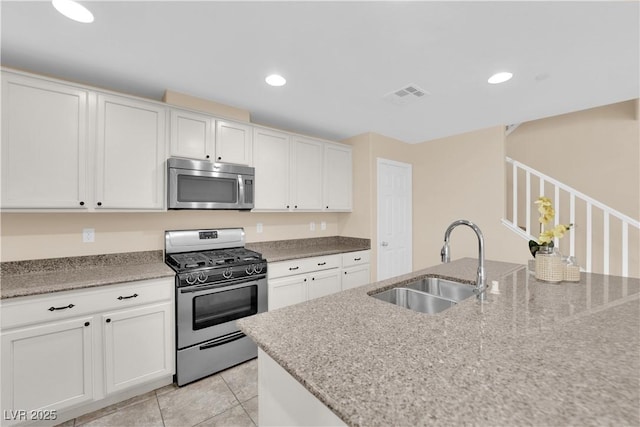 kitchen featuring light tile patterned floors, recessed lighting, visible vents, appliances with stainless steel finishes, and a sink