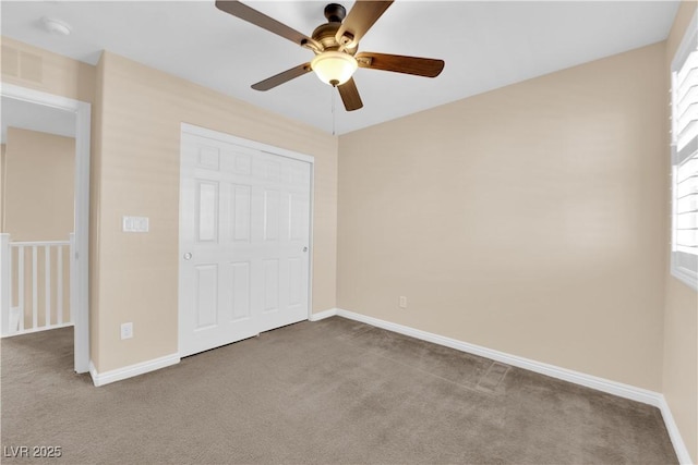 unfurnished bedroom with carpet, visible vents, baseboards, and ceiling fan