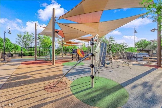 view of home's community with fence and playground community