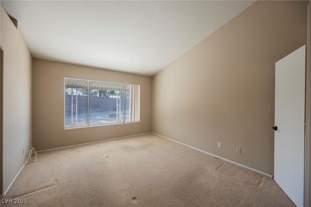 empty room with light colored carpet and baseboards