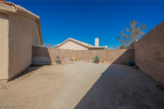 view of yard featuring a fenced backyard and a patio