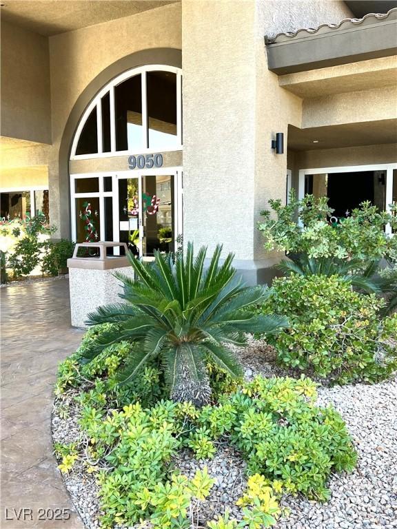 entrance to property featuring stucco siding