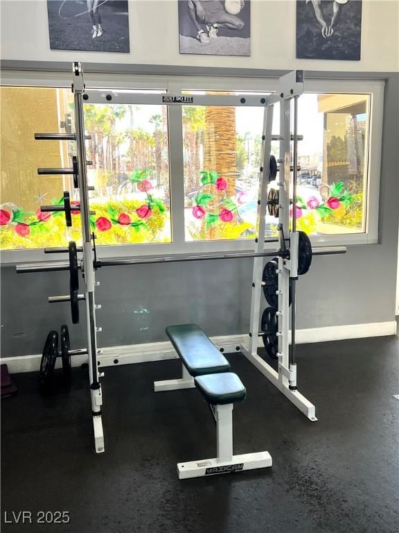 workout room featuring baseboards