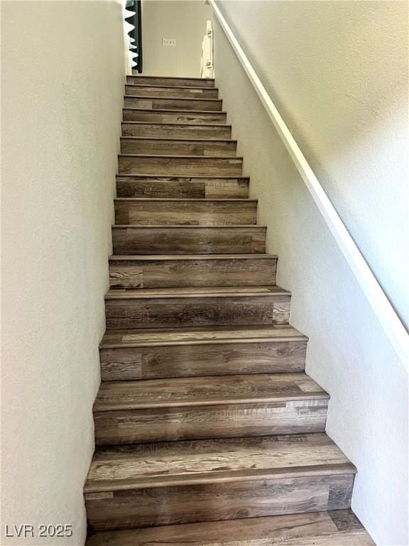 stairway featuring wood finished floors