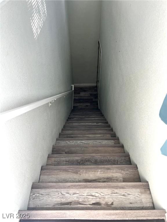 stairway with wood finished floors