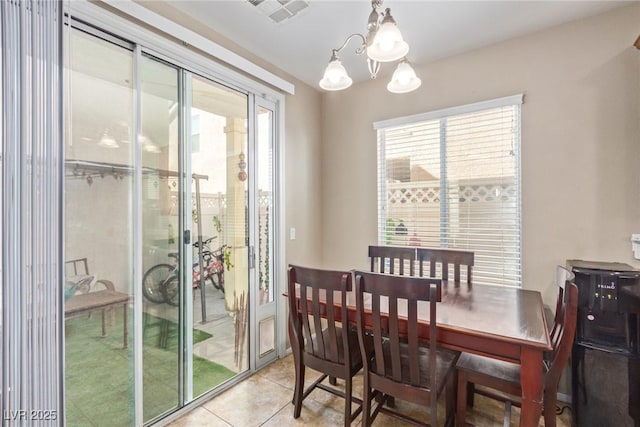 dining room with visible vents, an inviting chandelier, and light tile patterned floors