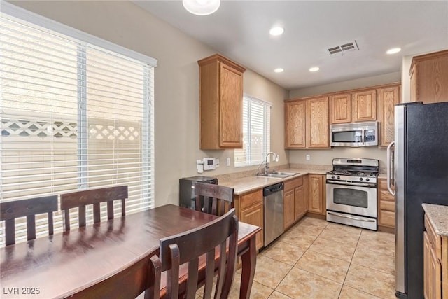 kitchen with light tile patterned floors, light countertops, visible vents, appliances with stainless steel finishes, and a sink