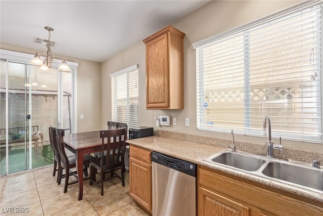 kitchen featuring light countertops, hanging light fixtures, visible vents, stainless steel dishwasher, and a sink