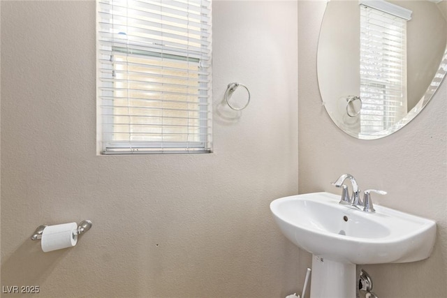 bathroom with a sink and a healthy amount of sunlight