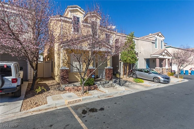 view of property with uncovered parking, fence, and stucco siding