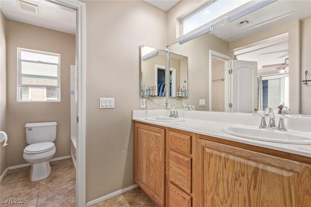 bathroom with visible vents, a sink, and toilet