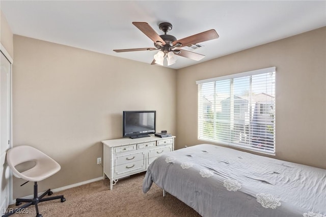 bedroom with baseboards, visible vents, a ceiling fan, and light colored carpet