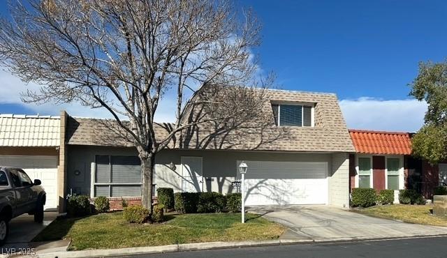 view of front of property featuring concrete driveway, brick siding, a tiled roof, and a front lawn