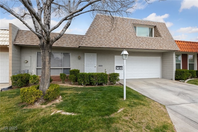 view of property featuring stucco siding, concrete driveway, a front yard, a shingled roof, and a garage