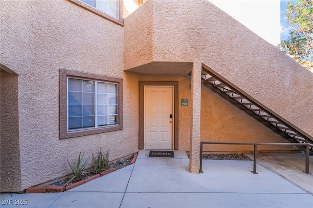 doorway to property with stucco siding