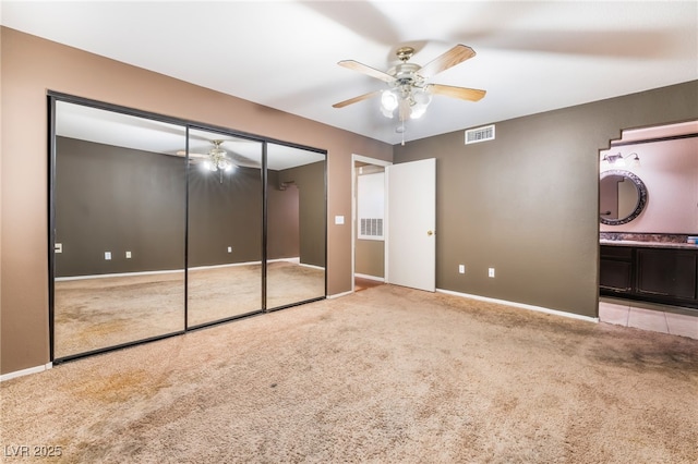 unfurnished bedroom featuring light carpet, baseboards, and visible vents