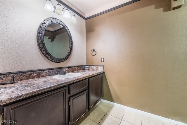 bathroom with tile patterned flooring, vanity, and baseboards