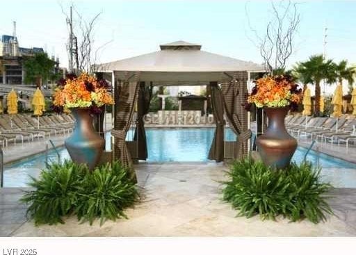 community pool featuring a gazebo and a patio area