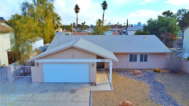 single story home with a garage, driveway, and fence