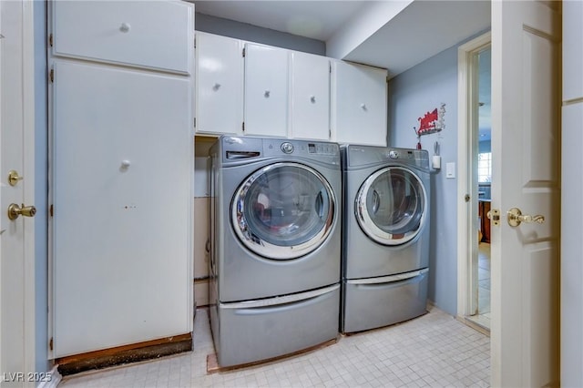 laundry room featuring cabinet space and washer and dryer