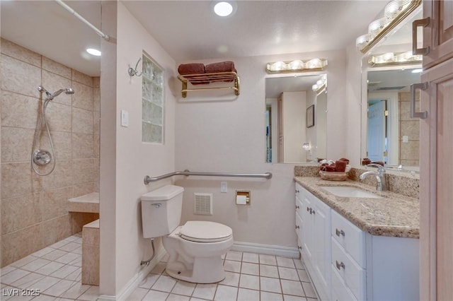 bathroom with toilet, vanity, walk in shower, baseboards, and tile patterned floors