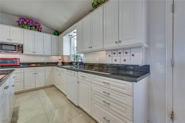 kitchen featuring a sink, white cabinetry, vaulted ceiling, dishwasher, and stainless steel microwave