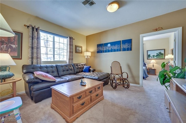 living area with light colored carpet, visible vents, and baseboards