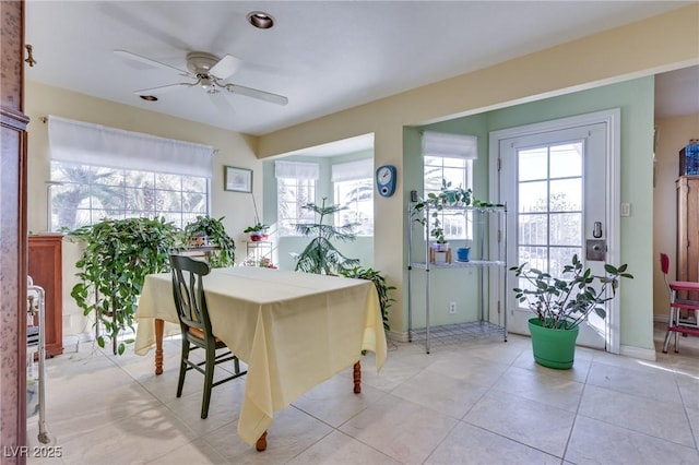 dining space with a healthy amount of sunlight, light tile patterned floors, and ceiling fan