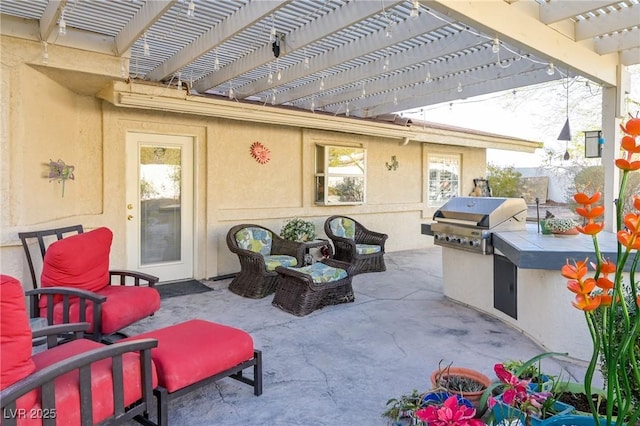 view of patio featuring area for grilling and a pergola