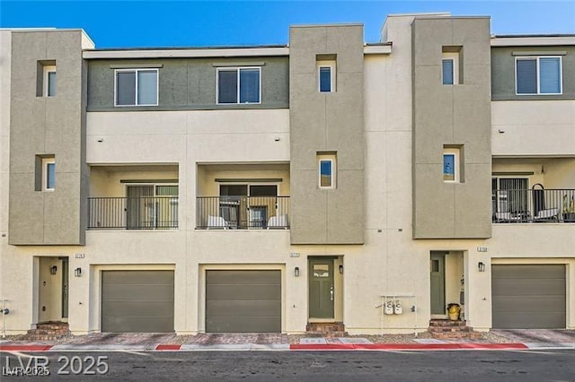 multi unit property featuring an attached garage and stucco siding