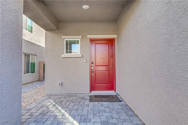 property entrance with stucco siding