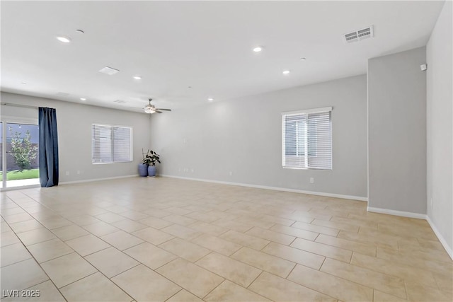 empty room featuring baseboards, light tile patterned floors, visible vents, and recessed lighting