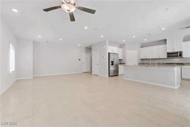 unfurnished living room featuring baseboards, a ceiling fan, visible vents, and recessed lighting