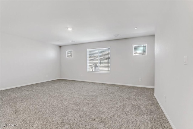 empty room featuring recessed lighting, carpet flooring, and baseboards