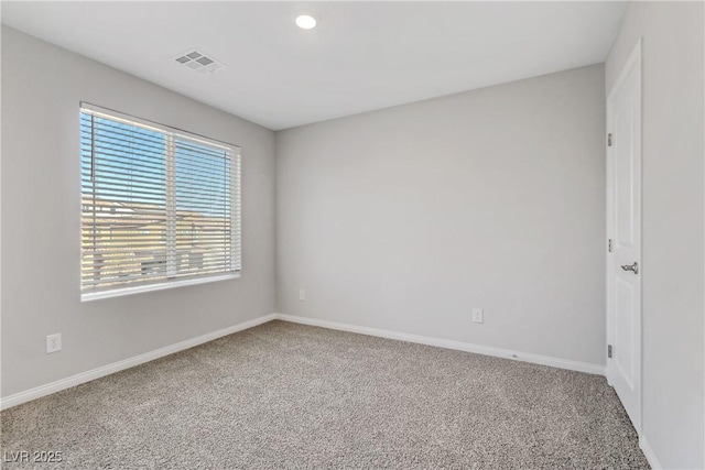 carpeted spare room with visible vents, baseboards, and recessed lighting