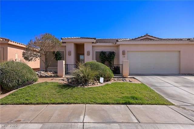 view of front of property featuring stucco siding, concrete driveway, a garage, a tiled roof, and a front lawn