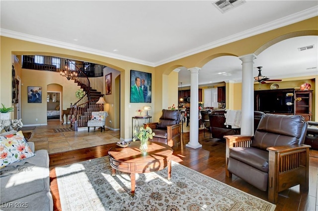 living room with ornate columns, wood-type flooring, visible vents, and arched walkways