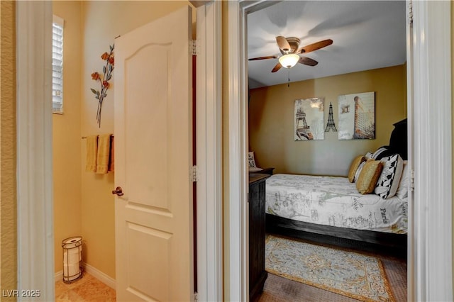 bedroom featuring ceiling fan and baseboards