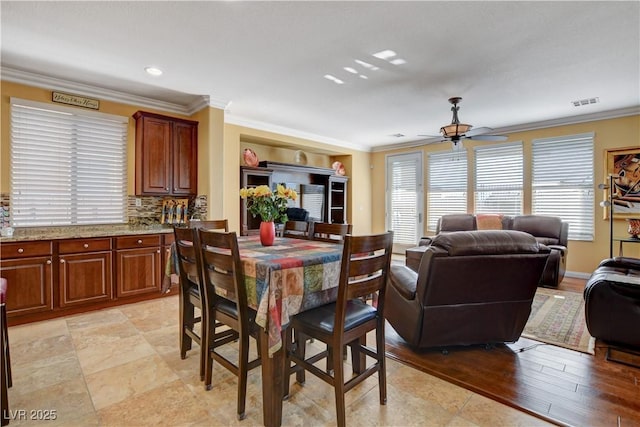 dining space featuring ceiling fan, visible vents, crown molding, and recessed lighting