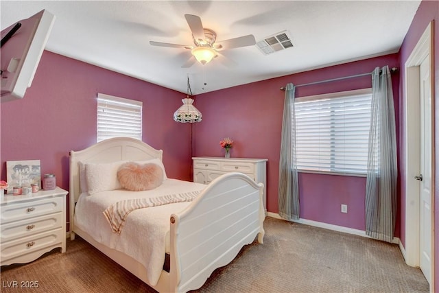 bedroom with baseboards, a ceiling fan, visible vents, and light colored carpet